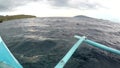 Boat outriggers moving through ocean waves